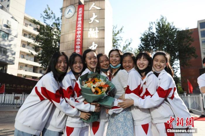 資料圖：6月10日，在北京人大附中高考考點外，考生們相擁拍照留念。當(dāng)日，北京市2021年高考結(jié)束?！?<a target='_blank'  data-cke-saved- ><p  align=